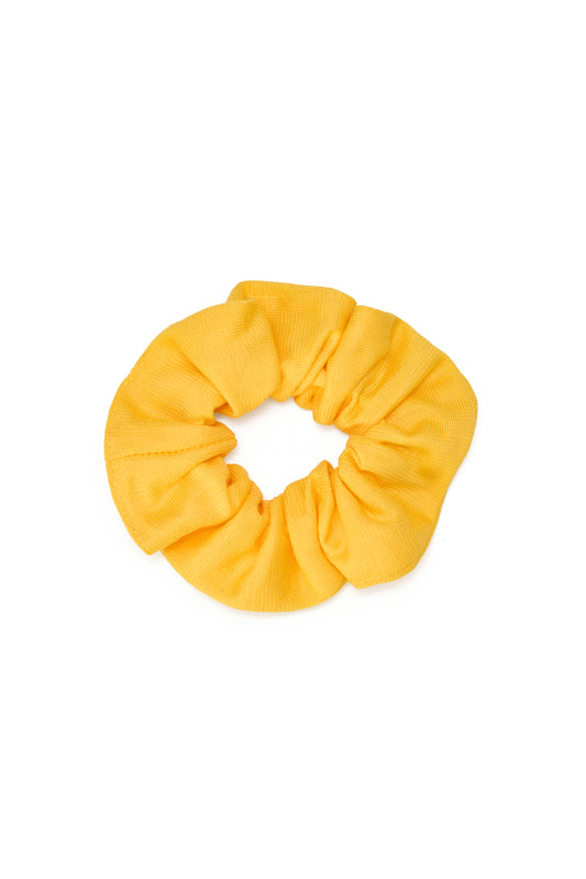 Zero waste yellow scrunchie made from GOTS certified organic cotton and biodegradable materials by Wellicious – a Cradle to Cradle Certified® hair accessory designed for sustainable, non-toxic, and circular fashion.
