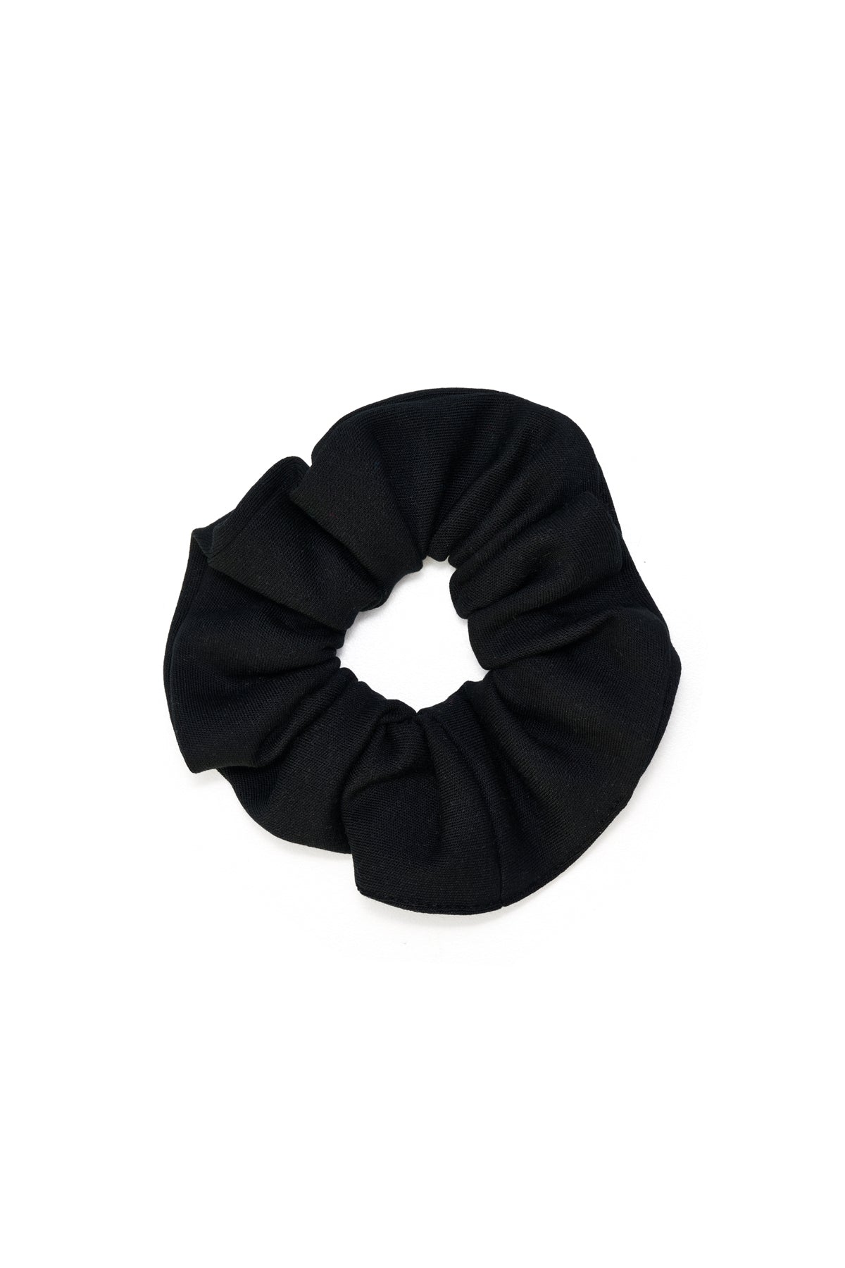 Eco-conscious black scrunchie made from biodegradable, Cradle to Cradle Certified® fabric by Wellicious – sustainable zero-waste hair accessory