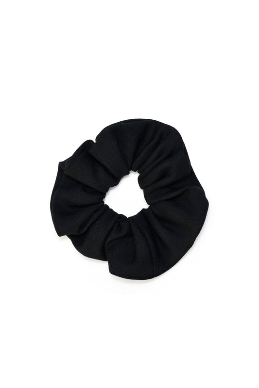 Eco-conscious black scrunchie made from biodegradable, Cradle to Cradle Certified® fabric by Wellicious – sustainable zero-waste hair accessory
